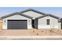 Attractive single-story home showcases a two-car garage, neutral paint, and minimal desert landscaping for a clean aesthetic at 4812 W Hunter Trl, San Tan Valley, AZ 85144