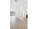 Bright living room with wood-look tile flooring and ample natural light, offering a modern and inviting space at 4812 W Hunter Trl, San Tan Valley, AZ 85144