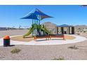 Community playground with vibrant play structure, benches, picnic shelter and mountain views at 4812 W Hunter Trl, San Tan Valley, AZ 85144