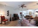 Comfortable living room featuring a ceiling fan, wood floors, and an open layout at 5350 E Deer Valley Dr # 4430, Phoenix, AZ 85054