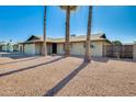 Charming single-story home featuring a desert landscaping with mature palms at 5513 W Tierra Buena Ln, Glendale, AZ 85306