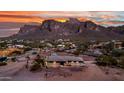 Aerial view of a single story home with desert landscaping surrounded by desert vegetation and mountain views at 5962 E Siesta St, Apache Junction, AZ 85119