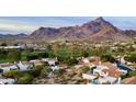 Scenic community nestled near mountains, featuring tile-roofed homes and lush landscaping at 6188 N 29Th Pl, Phoenix, AZ 85016