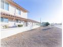 Exterior view of a building with light stucco, a brick roof, and address sign at 6454 E University Dr # 5, Mesa, AZ 85205