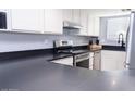 Close-up of the kitchen with stainless steel appliances and dark countertop at 6454 E University Dr # 5, Mesa, AZ 85205