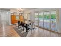 Bright dining area with modern light fixture and sliding door to the backyard at 6634 N 16Th Dr, Phoenix, AZ 85015