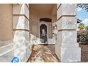 Inviting entryway with decorative pillars, stone tile flooring, and a secure wrought-iron gate at 698 W Merrill Ave, Gilbert, AZ 85233