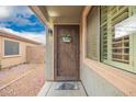 Inviting front entrance with security door, decorative welcome sign, and a 