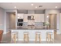 Modern kitchen with stainless steel appliances, ample counter space, and seating at the island at 7472 E Paraiso Dr, Scottsdale, AZ 85255