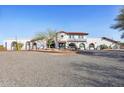 Stunning estate with white stucco, red tile roof, mature landscaping, circular drive and beautiful arched windows at 7650 E Culver St, Mesa, AZ 85207