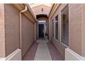 Inviting front entryway featuring decorative door with privacy screen and stone-lined walkway at 8157 E Apache Plumb Dr, Gold Canyon, AZ 85118