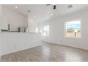 Bright and airy living area with tile floors, open to the kitchen, with modern windows at 9504 W Century Dr, Arizona City, AZ 85123