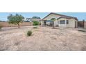 Large, private backyard with mature trees, offering ample space for entertaining and outdoor activities at 12425 N 127Th Dr, El Mirage, AZ 85335