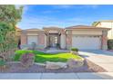 Charming single-story home featuring well-maintained landscaping, a two-car garage, and a welcoming entrance at 12607 W Highland Ave, Litchfield Park, AZ 85340