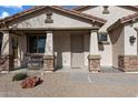 Inviting front porch with stone accents and a cozy seating area, perfect for relaxing outdoors at 17286 W Morning Glory St, Goodyear, AZ 85338