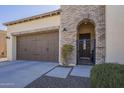 Garage exterior showing driveway and landscaped walkway to a gated entrance at 1775 E Tangelo Pl, Queen Creek, AZ 85140