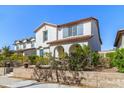 Attractive two-story home with a red tile roof, stucco walls, arched entry, and landscaped yard at 20728 W Legend Trl, Buckeye, AZ 85396