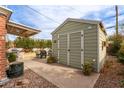 Backyard featuring a storage shed, outdoor seating area, and green foliage at 2315 N 12Th St, Phoenix, AZ 85006