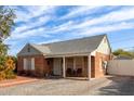 A charming brick home featuring a cozy front porch, brick paved driveway and tidy landscaping at 2315 N 12Th St, Phoenix, AZ 85006