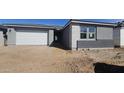 New construction home displaying a gray exterior with a white garage door and desert landscaping at 2674 E Abe Truckle Ave, San Tan Valley, AZ 85140