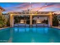 Resort-style pool with waterfall features, ambient lighting, and lush greenery, perfect for relaxation at 2733 E Virginia St, Gilbert, AZ 85296