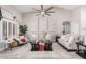 Bright living room featuring vaulted ceilings, stylish decor, and neutral color palette at 30427 W Vale Dr, Buckeye, AZ 85396