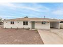 Charming single-story home showcasing a neutral color palette, low maintenance landscaping, and an attached carport at 325 W Vineyard Rd, Phoenix, AZ 85041