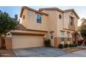 Two-story home featuring a stucco exterior, a two-car garage, and a covered front entry at 4225 E Carla Vista Dr, Gilbert, AZ 85295