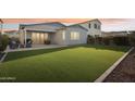Spacious backyard features artificial grass, covered patio, and outdoor seating area at 4370 E Kaibab Pl, Chandler, AZ 85249
