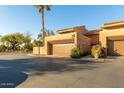 Inviting home exterior featuring a desert landscape, garage, and private entrance at 4434 E Camelback Rd # 128, Phoenix, AZ 85018