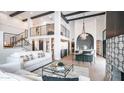Bright, modern living room with soaring ceilings, black beams, and comfortable white sofas at 4434 E Camelback Rd # 128, Phoenix, AZ 85018