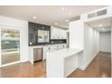 Bright kitchen featuring sleek countertops, white cabinetry, stainless steel appliances, and a modern backsplash at 4721 N 24Th St, Phoenix, AZ 85016
