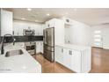 Modern kitchen with stainless steel appliances, white cabinets, quartz countertop, and a stylish backsplash at 4721 N 24Th St, Phoenix, AZ 85016