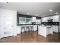 Bright, open kitchen with white cabinetry, modern appliances, large windows and a center island with seating at 4729 N 24Th St, Phoenix, AZ 85016