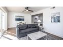 Inviting living room featuring a modern sofa, decorative artwork, a ceiling fan and lots of natural light at 4729 N 24Th St, Phoenix, AZ 85016