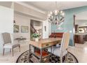 Inviting home office featuring a built-in desk, chandelier, and neutral decor at 4937 W Desert Hollow Dr, Phoenix, AZ 85083