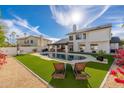 Beautiful backyard featuring a sparkling pool, lush turf, and lounge chairs at 5010 E Nisbet Rd, Scottsdale, AZ 85254