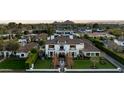 Aerial view of a beautiful luxury home with mature landscaping and a well manicured lawn at 5915 E Calle Del Sud --, Phoenix, AZ 85018