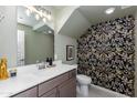 Stylish powder room with unique patterned wallpaper, contemporary fixtures, and a sleek vanity at 651 N Ironwood Dr # 2, Apache Junction, AZ 85120