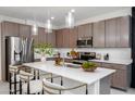 Bright kitchen features a large island, pendant lighting, stainless steel appliances, and ample cabinet space at 651 N Ironwood Dr # 3, Apache Junction, AZ 85120
