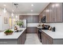 Modern kitchen boasts stainless steel appliances, stone countertops, and stylish undermount sink at 651 N Ironwood Dr # 7, Apache Junction, AZ 85120