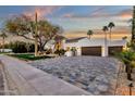 Paver driveway leading to a white stucco home exterior at 8713 N 80Th Pl, Scottsdale, AZ 85258