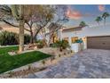 Charming front yard with desert landscaping and a white stucco home exterior at 8713 N 80Th Pl, Scottsdale, AZ 85258