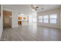 Inviting living room offering open layout, ceiling fan, and views of kitchen area at 9325 W Hazelwood St, Phoenix, AZ 85037