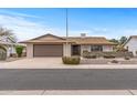 Inviting single-story home with a well-maintained front yard, desert landscaping and an attached garage at 10956 W Meade Dr, Sun City, AZ 85351