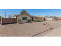 Single-story home with desert landscaping and a private fenced front yard at 11468 N Desert Hills Dr, Sun City, AZ 85351