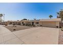 Traditional style home with a wide driveway and beautiful desert landscaping at 11468 N Desert Hills Dr, Sun City, AZ 85351