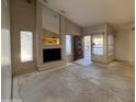 Spacious living room featuring a fireplace, large windows and an open floor plan ready for renovations at 1384 N Santa Anna Ct, Chandler, AZ 85224