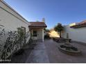 Private courtyard features mature landscaping, an outdoor seating area, and a decorative fountain at 1384 N Santa Anna Ct, Chandler, AZ 85224