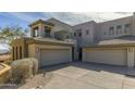 Exterior elevation of a multi-story home, boasting a three-car garage and desert landscape at 14850 E Grandview Dr # 233, Fountain Hills, AZ 85268